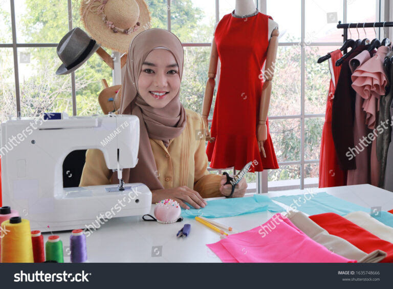 stock photo beautiful young woman muslim dressmaker tailor or fashion designer in hijab is working in 1635748666 768x564